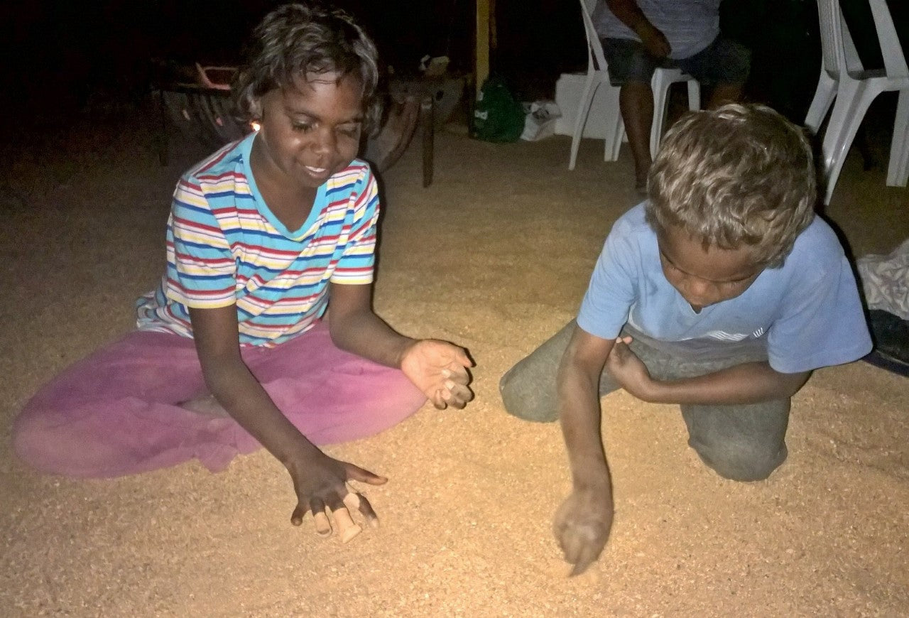 Aboriginal artist with their Dreaming artwork