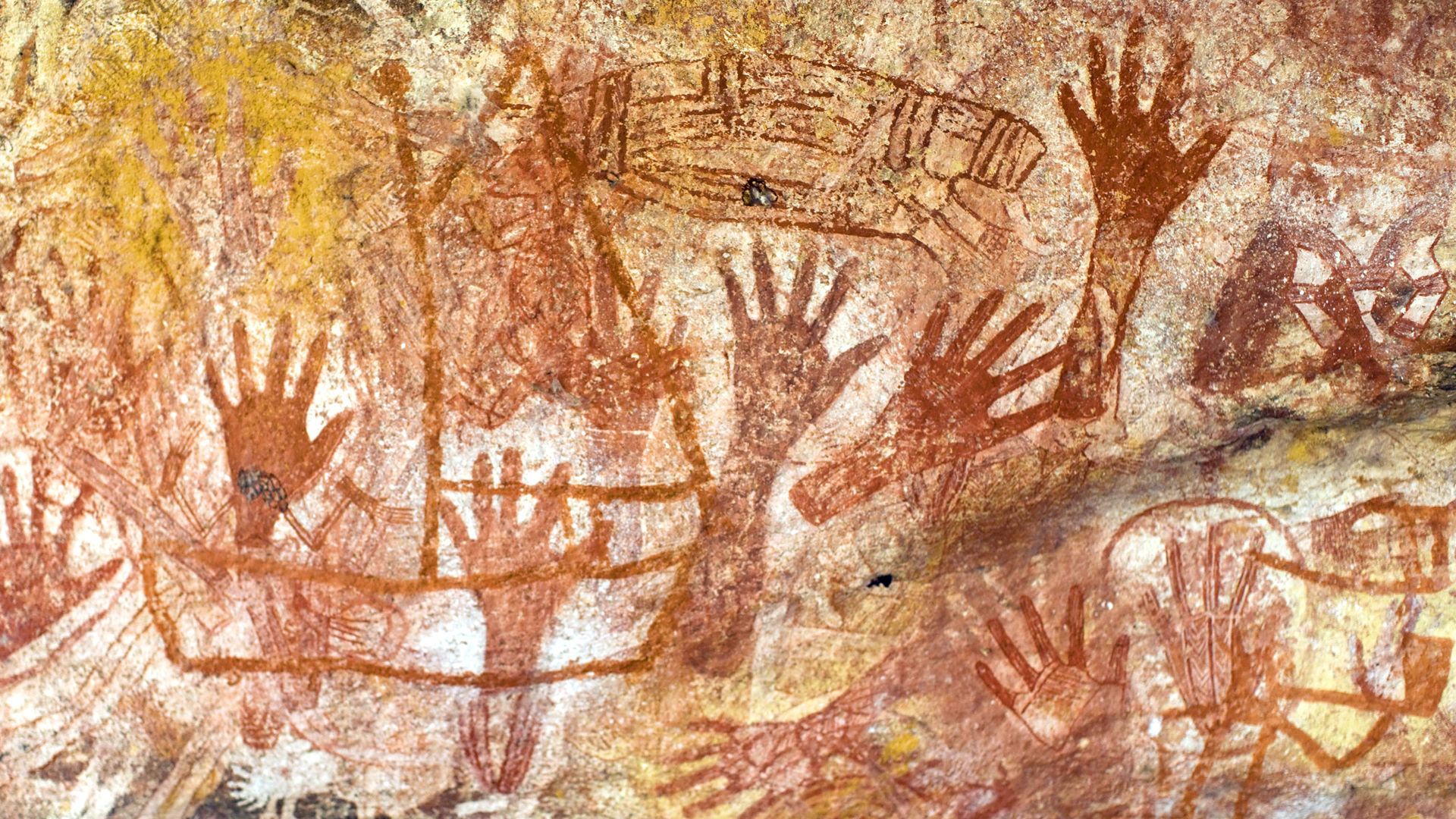 Hand stencils in ochre on rock, an early Aboriginal image-making tradition