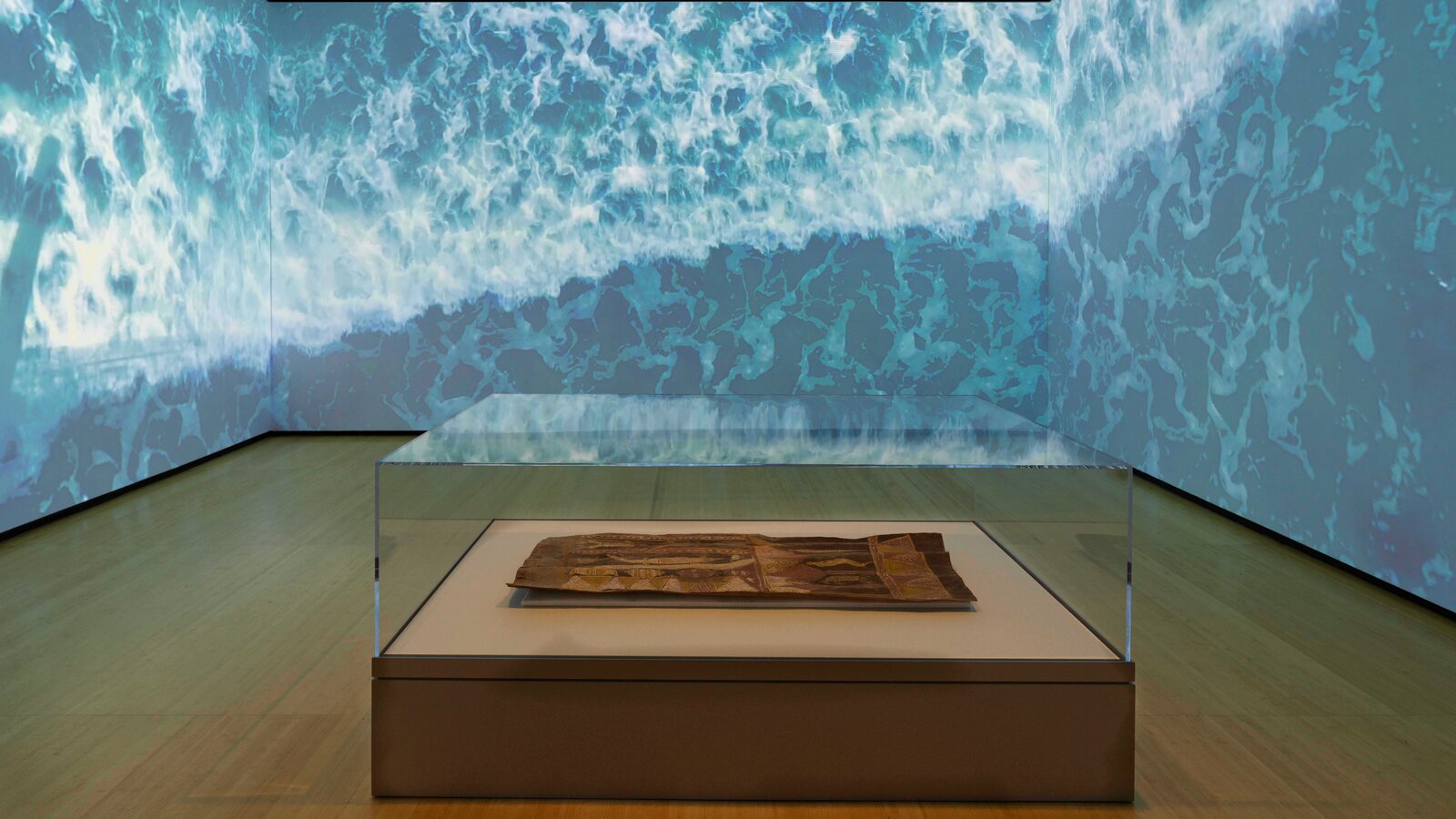 Traditional Aboriginal bark painting displayed in a museum gallery