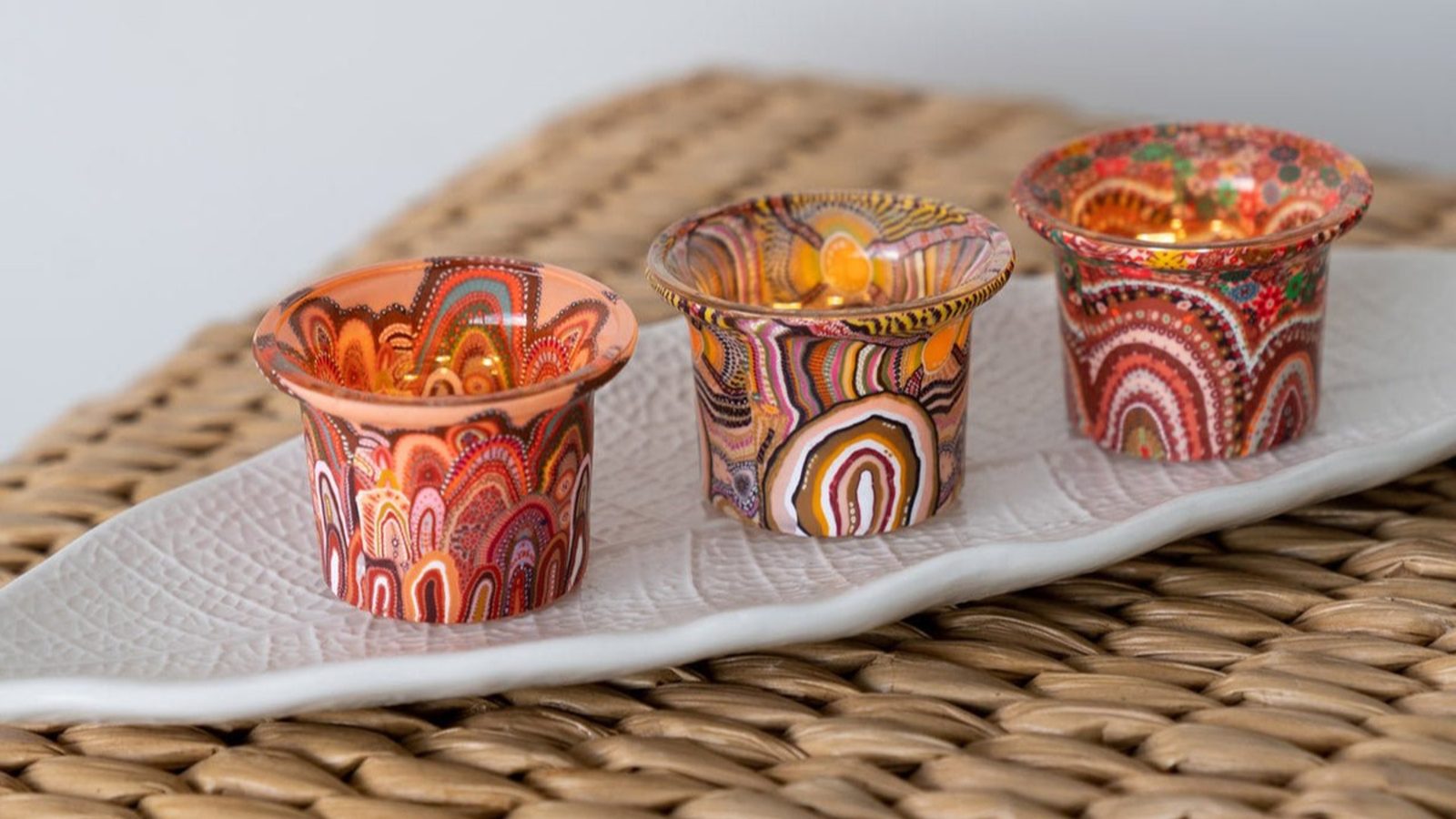 Aboriginal art homewares display with pillowcases, table runners and candles