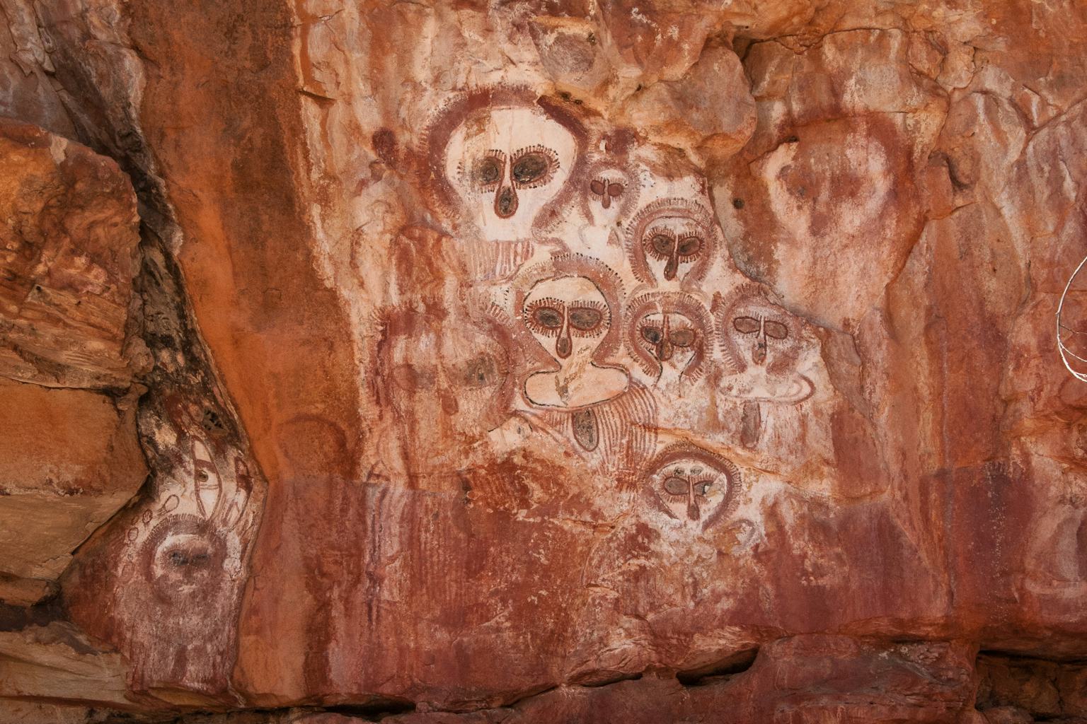 Researcher sampling a rock art panel for dating analysis