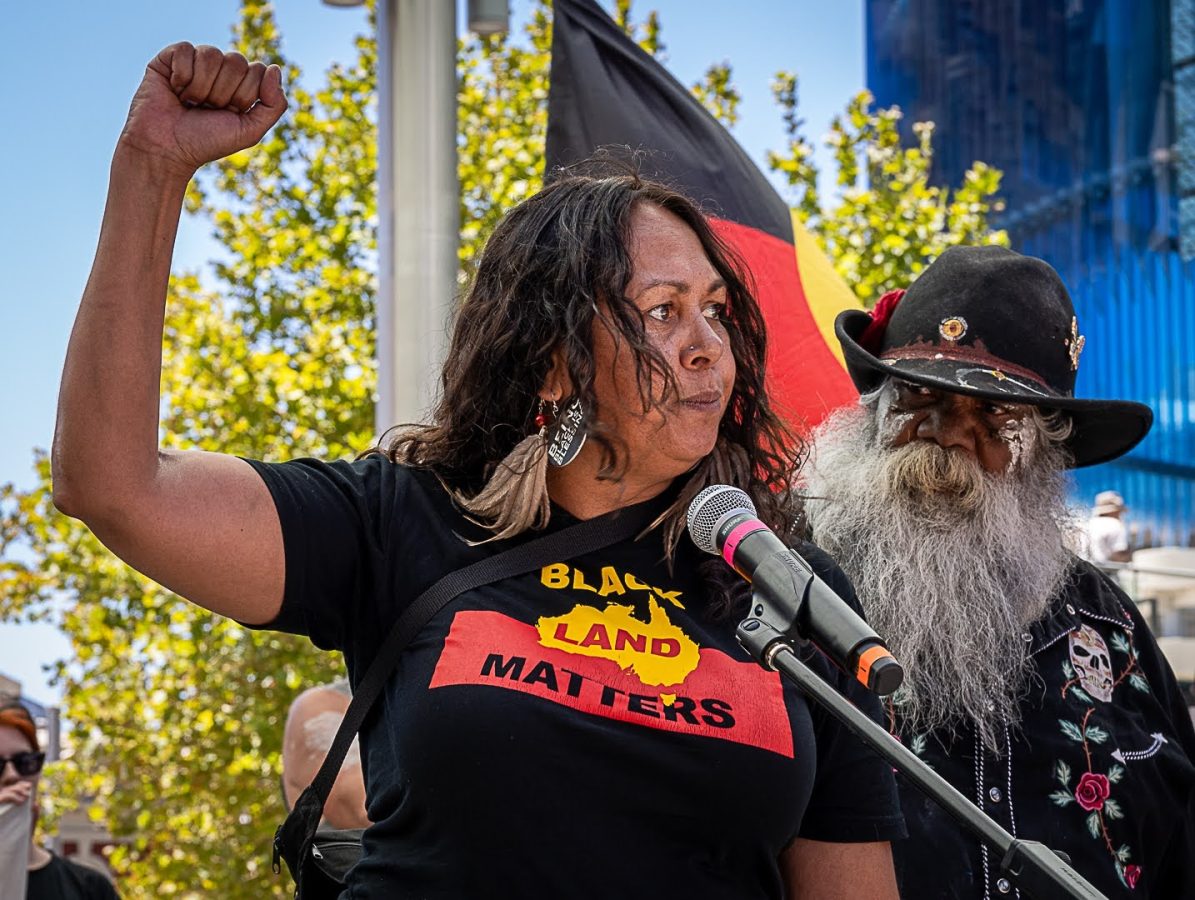 Invasion Day rally with First Nations flag