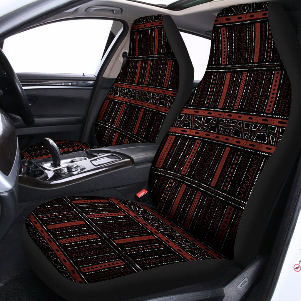 Dark red and black Aboriginal pattern car seat covers fitted in a car